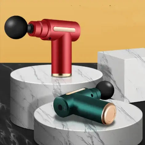 Professional Fascia Gun Massager in red and green colors displayed on marble platforms.